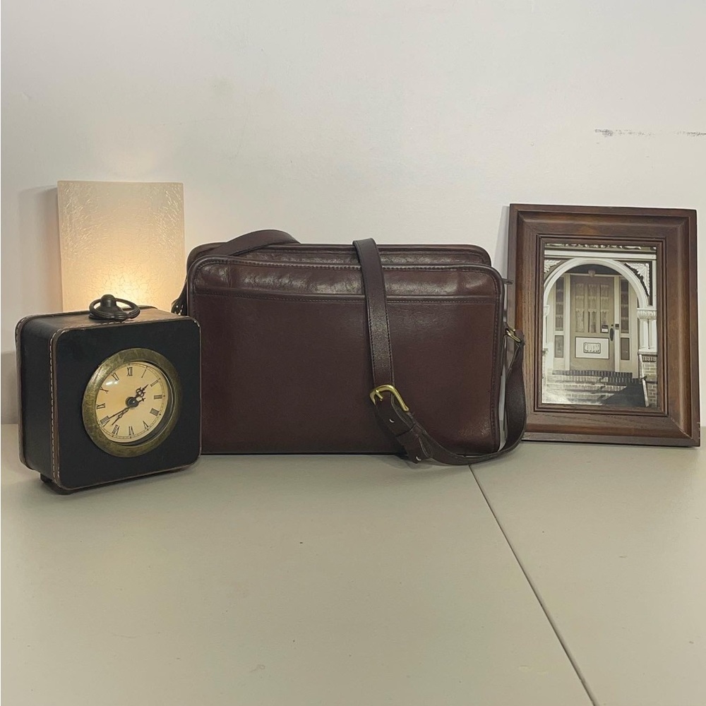 Women’s chocolate colored coach saddle bag with strap